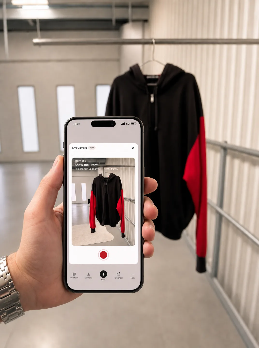 A hand holding a phone, filming a black and red hoodie with the Ragpiq app